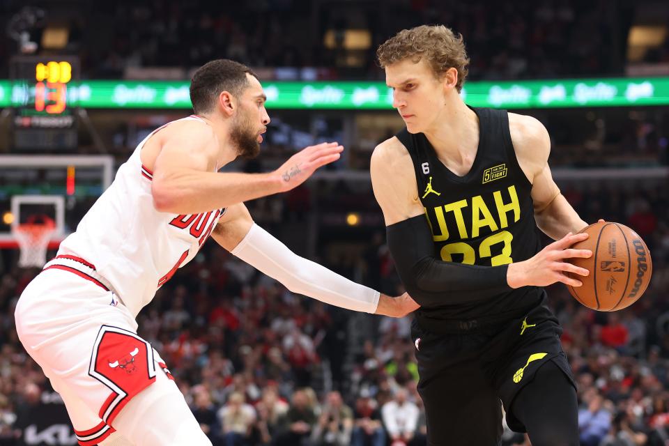 Lauri Markkanen #23 of the Utah Jazz is defended by Zach LaVine #8 of the Chicago Bulls.