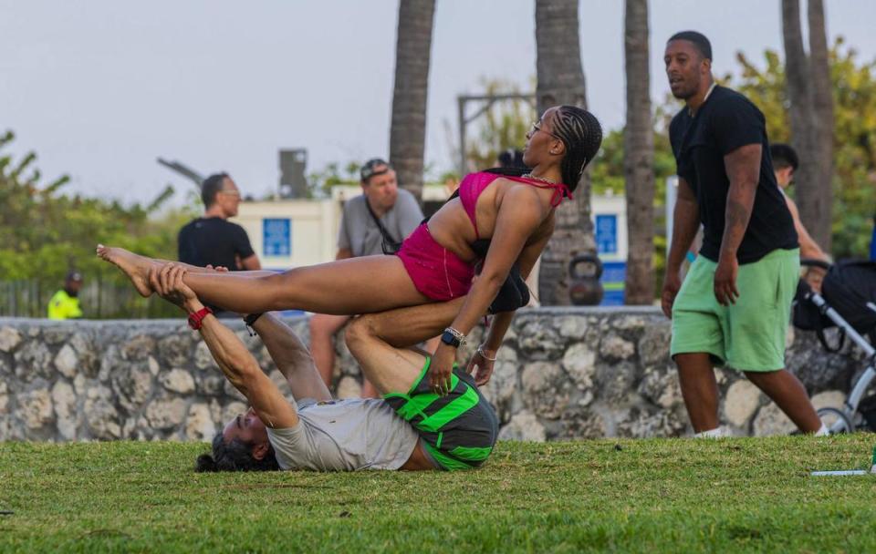 Amia Campbell of Brooklyn practices calisthenics with local resident Hivo Gonzalez on Ocean Drive during spring break in Miami Beach on Saturday March 9, 2024.