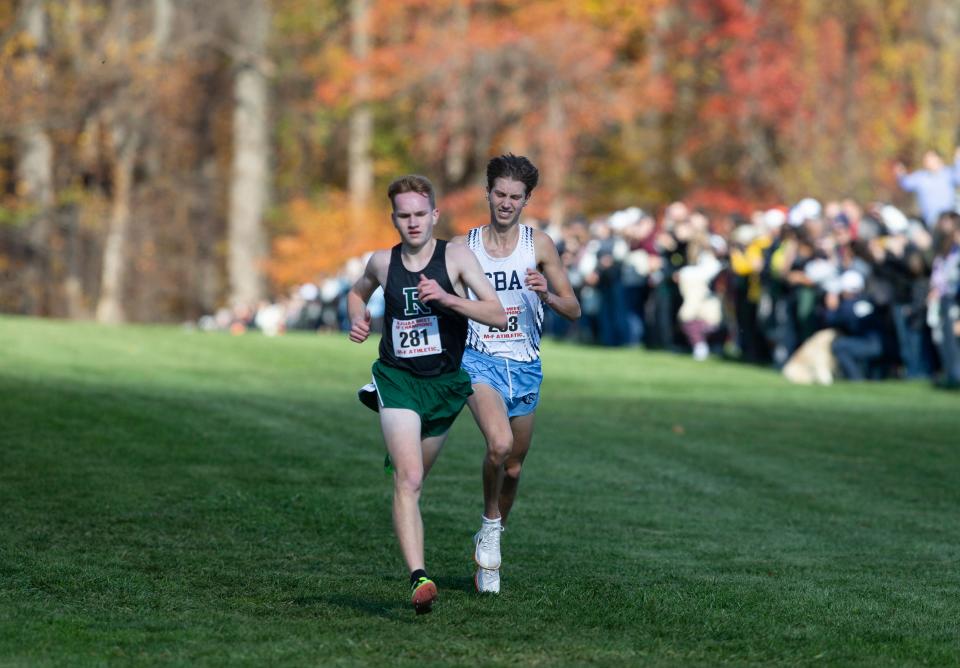 CBA'S Alex Kemp (right) passes a runner down the stretch at the Meet of Champions