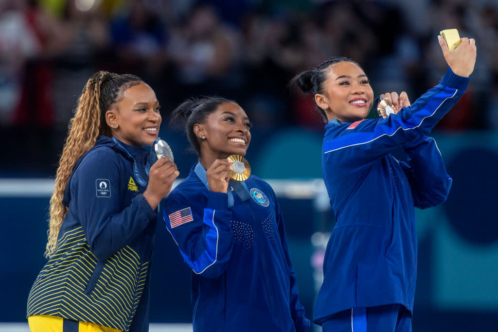 Silver medal winner Rebeca Andrade of Brazil, gold medal winner Simone Biles of Team USA and bronze medal winner Sunisa Lee of Team USA, take a selfie with their medals during the Paris 2024 Summer Olympic Games on August 1st, 2024 in Paris, France.<span class="copyright">Tim Clayton—Corbis via Getty Images</span>