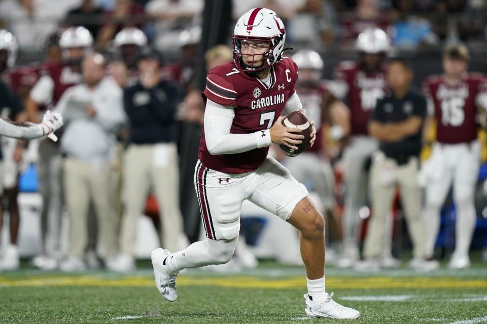 South Carolina quarterback Spencer Rattler runs in the pocket during the first half of an NCAA college football game against North Carolina Saturday, Sept. 2, 2023, in Charlotte, N.C. (AP Photo/Erik Verduzco)