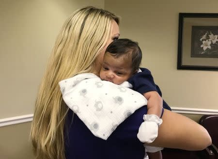 Medical assistant McKenzie Coleman holds Thomas P. Sanders, who was born in May 2017 in Bay Minette, Alabama, U.S. on June 22, 2017. REUTERS/Jilian Mincer