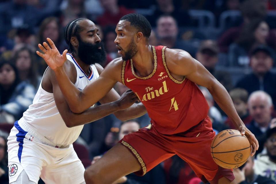 Cleveland Cavaliers forward Evan Mobley (4) drives against Los Angeles Clippers guard James Harden, left, during the first half of an NBA basketball game, Monday, Jan. 29, 2024, in Cleveland. (AP Photo/Ron Schwane)