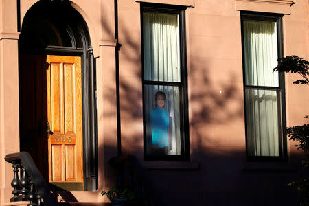 A photo of Democratic presidential candidate Hillary Clinton is seen on a window in the Carroll Gardens neighborhood of Brooklyn, New York, U.S., September 23, 2016. Picture taken September 23, 2016. REUTERS/Brendan McDermid