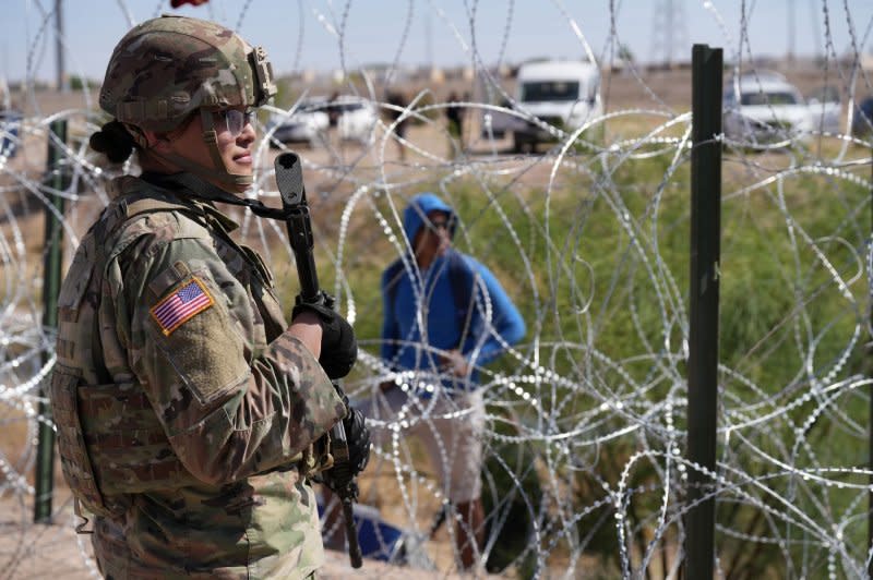 Members of the Operation Lone Star Task Force West and Texas Tactical Border Force block migrants from illegally entering Texas on May 11. File Photo by Mark Otte/Texas Army National Guard