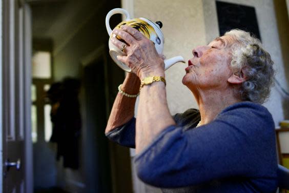 Kerr drinks from a tea pot in 2015 as she recreates a scene from ‘The Tiger Who Came To Tea’ (Reuters)