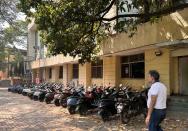 A man walks past Ola electric scooters outside the Ola Electric Service Centre, in Thane on the outskirts of Mumbai