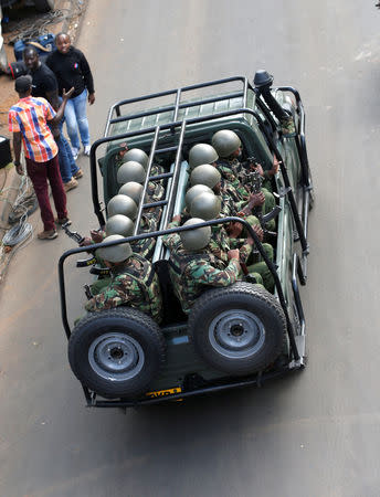 Kenyan policemen ride in a truck as they leave the scene where explosions and gunshots were heard at the Dusit hotel compound in Nairobi, Kenya, January 16, 2019. REUTERS/Thomas Mukoya