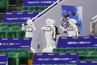 Humanoid robot Peppers are seen in the seats at a stadium during an opening baseball game between Fukuoka SoftBank Hawks and Chiba Lotte Marines in Fukuoka, western Japan, Friday, June 19, 2020. After a three-month delay caused by the coronavirus pandemic, the world's second-most famous baseball league opened a shortened season Friday without the presence of fans. (Kyodo News via AP)/Kyodo News via AP)