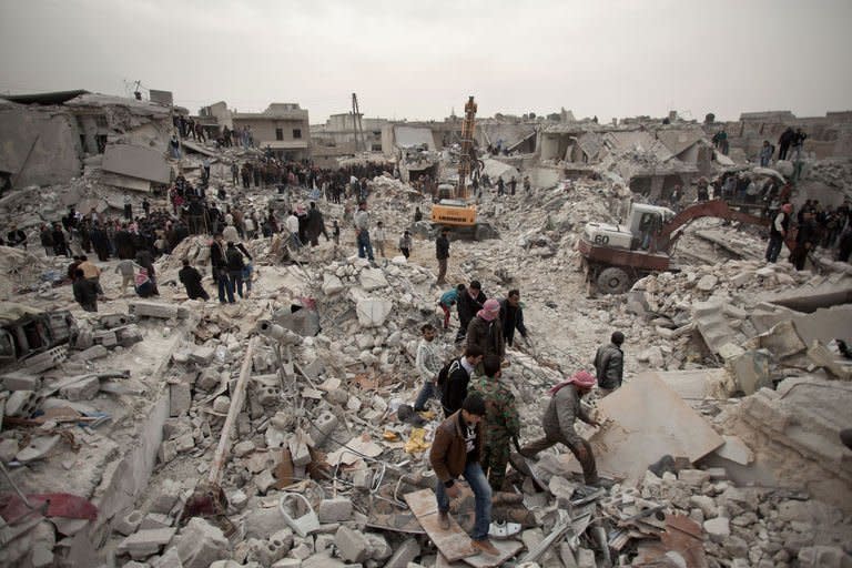 Syrians search for survivors and bodies amid the rubble of buildings in the Tariq al-Bab district of the northern city of Aleppo on February 23, 2013. On Sunday alone, according to a toll compiled by the Syrian Observatory for Human Rights, at least 105 people were killed in violence across the country