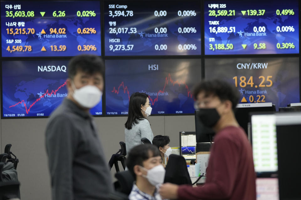 Currency traders watch monitors at the foreign exchange dealing room of the KEB Hana Bank headquarters in Seoul, South Korea, Friday, Oct. 22, 2021. Asian shares were mixed Friday after a late-in-the-day wave of buying pushed the S&P 500 to a fresh record high. (AP Photo/Ahn Young-joon)