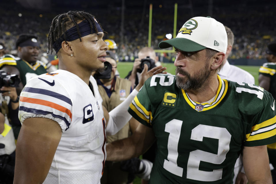 Green Bay Packers quarterback Aaron Rodgers (12) talks with Chicago Bears quarterback Justin Fields (1) after an NFL football game Sunday, Sept. 18, 2022, in Green Bay, Wis. The Packers won 27-10. (AP Photo/Matt Ludtke)