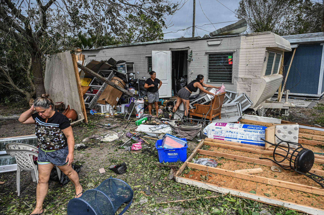 Residents of mobile homes clean up debris in the aftermath of Hurricane Ian (Giorgio Viera / AFP via Getty Images)