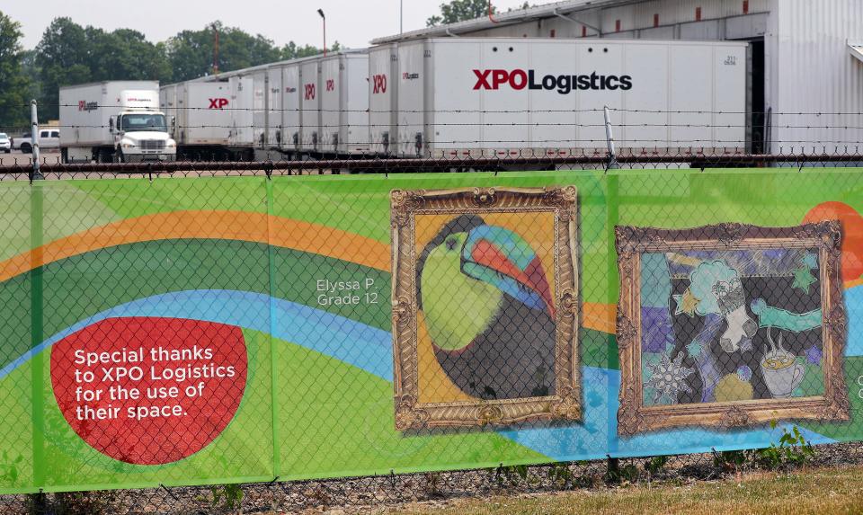 The artwork of students from the Green Local School District is showcased on the fence in front of XPO Logistics.