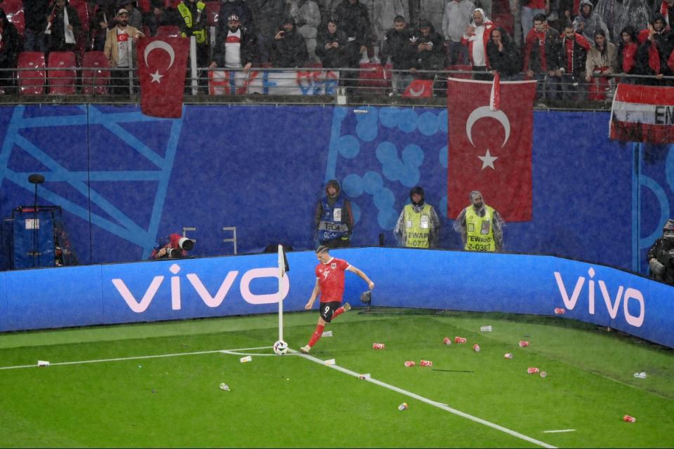 A number of cups were also tossed on to the playing area (Getty Images)