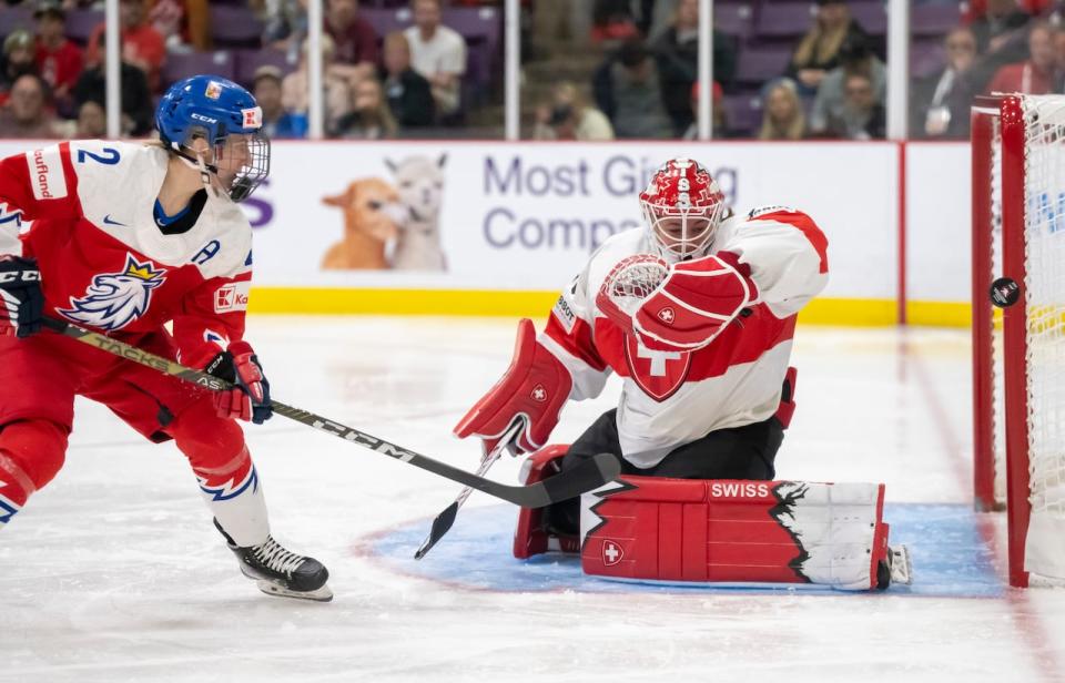 Tejralová shoots a puck off the post past Switzerland goaltender Andrea Braendli during the bronze-medal game at the women's world hockey championship in April.