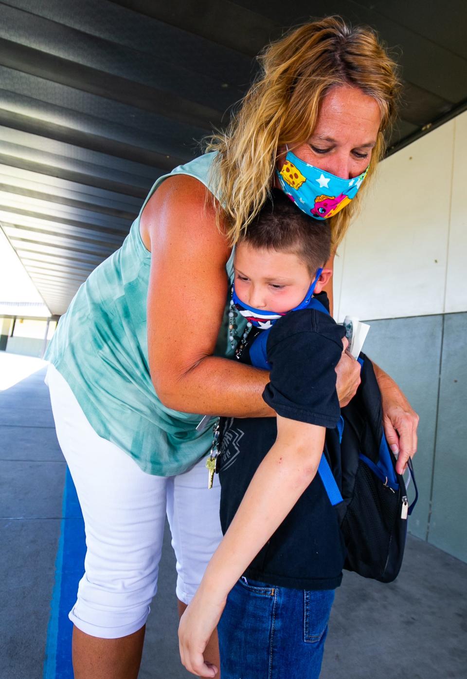 Belleview-Santos Elementary School counselor Cindy Hayes gives second grader Landon Hicks, 8, a hug on the last day of school in May 2021.