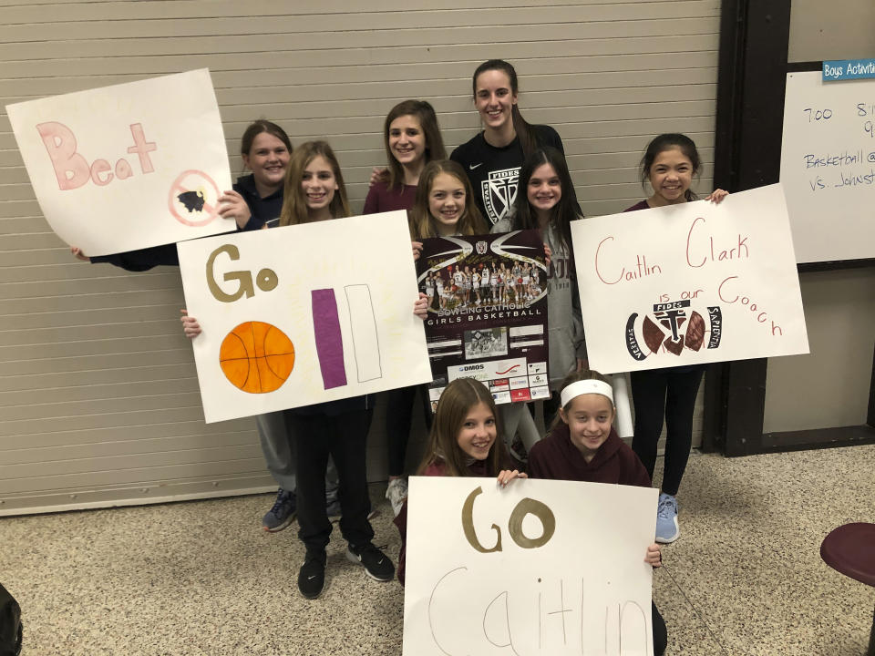 In this photo provided by Leah Reidl, Caitlin Clark poses with members of the middle school basketball team she helped coach at Dowling Catholic High School in West Des Moines, Iowa, Dec. 9, 2019. (Leah Reidl via AP)