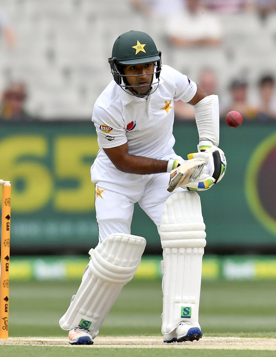 Pakistan's Asad Shafiq plays a defensive shot against Australia on the second day of their second cricket test match in Melbourne, Australia, Tuesday, Dec. 27, 2016. (AP Photo/Andy Brownbill)