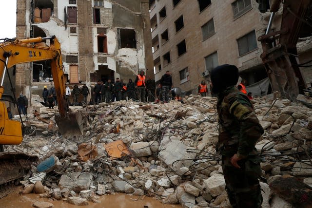 People search through the wreckage of collapsed buildings in Hama, Syria 