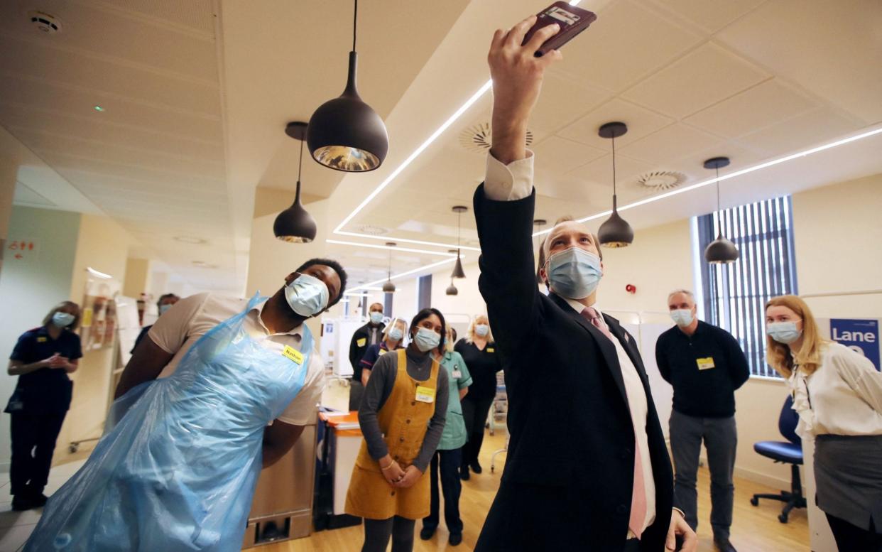 Matt Hancock takes a selfie with vaccine hub staff at the Queen Elizabeth Hospital, Birmingham, earlier this month - Molly Darlington/AFP via Getty Images