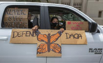 FILE - In this June 18, 2020, file photo, people hold signs during a vehicle caravan rally to support the Deferred Action for Childhood Arrivals Program (DACA), around MacArthur Park in Los Angeles. Immigrant rights activists energized by a new Democratic administration and majorities on Capitol Hill are gearing up for a fresh political battle. A coalition of national advocacy groups on Monday announced a multimillion-dollar campaign to help push through President Joe Biden’s plan to open a citizenship pathway for up to 11 million people. (AP Photo/Damian Dovarganes, File)