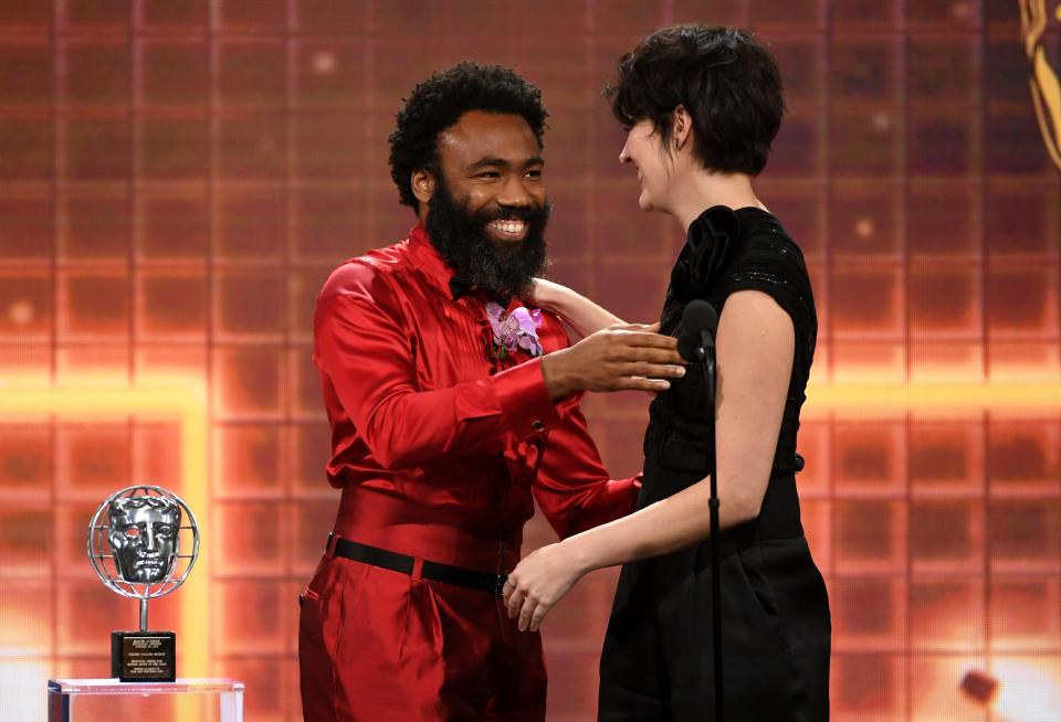 Former co-stars, rapper and actor Donald Glover, and British actress Phoebe Waller-Bridge on stage at the 2019 British Academy Britannia Awards in 2019.