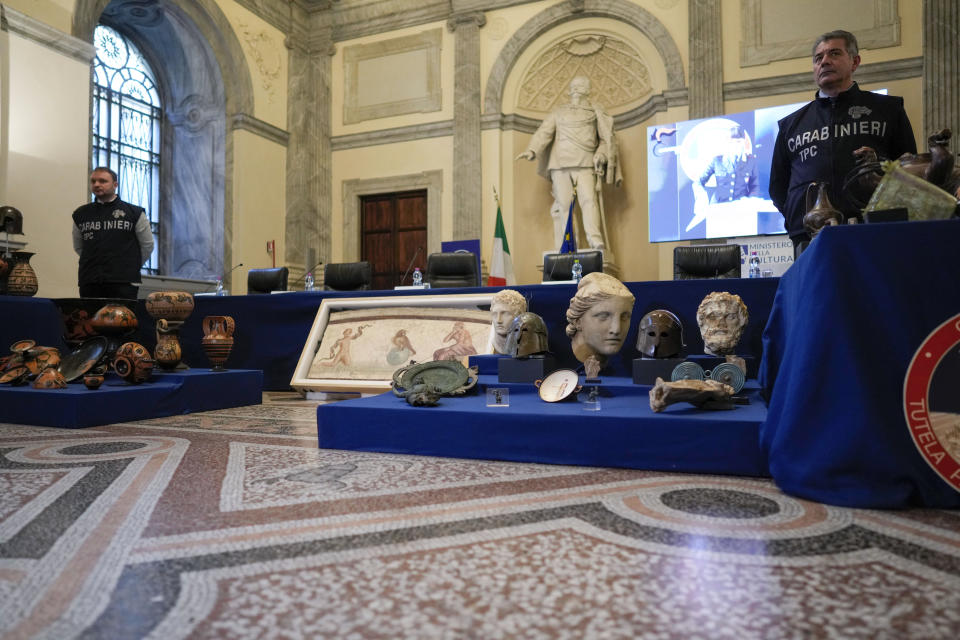 60 archaeological artifacts stolen from Italy and sold in the US by international art traffickers are seen on display during a press conference in Rome, Monday, Jan. 23, 2023. The stolen artifacts, for an estimated total value of 20 million dollars, have been recovered in private collections in the US and returned to Italy after a joint investigation by Italian Carabinieri police and the New York County District Attorney's Office. (AP Photo/Andrew Medichini)