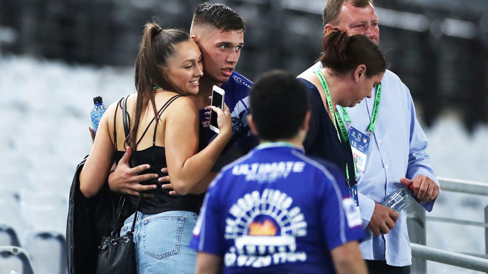 Jake Averillo, pictured here with his partner and family after his NRL debut in March.