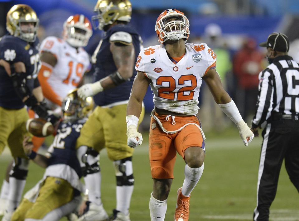 Clemson linebacker Trenton Simpson (22) celebrate after sacking Notre Dame quarterback Ian Book, back left, during the Atlantic Coast Conference championship NCAA college football game, Saturday, Dec. 19, 2020, in Charlotte, N.C. (Jeff Siner/The News & Observer via AP)