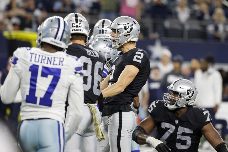 Las Vegas Raiders place kicker Daniel Carlson (2) celebrates kicking a game-winning field goal as Dallas Cowboys' Malik Turner (17) and Brandon Parker (75) look on in overtime of an NFL football game in Arlington, Texas, Thursday, Nov. 25, 2021. (AP Photo/Michael Ainsworth)