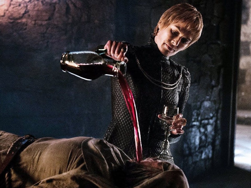 Cersei pouring wine into the mouth of Septa Unella