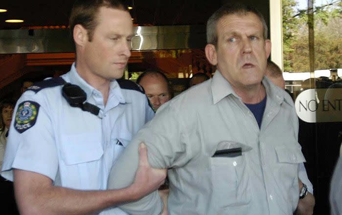 Nov. 10, 2003 file photo of Bradley John Murdoch being arrested by police at Adelaide's Sir Samuel Way court building. Photo: AAP Image/ Rob Hutchison, File