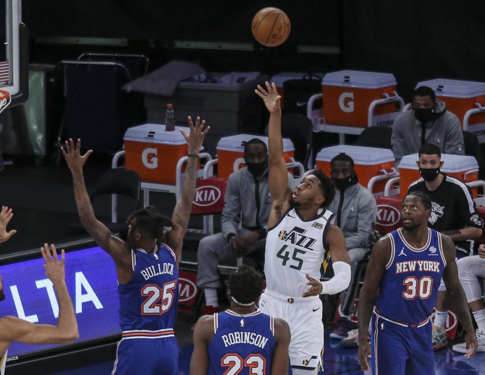 Utah Jazz guard Donovan Mitchell (45) shoots over New York Knicks forward Reggie Bullock (25) during the first half of an NBA basketball game Wednesday, Jan. 6, 2021, in New York. (Wendell Cruz/Pool Photo via AP)