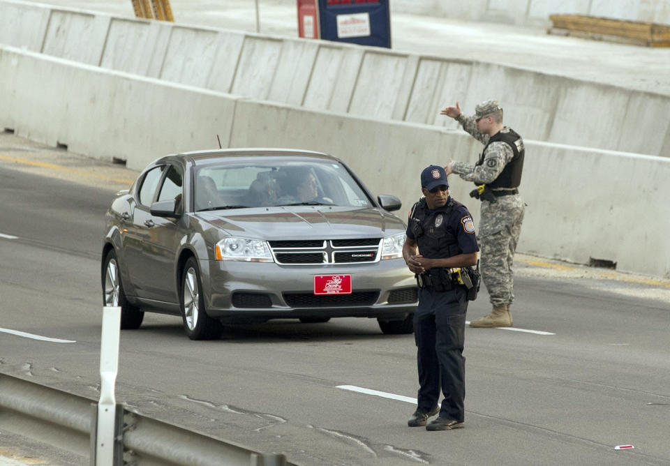 Vehicles are checked at the Bernie Beck Main Gate at Fort Hood, Texas, April 2, 2014.