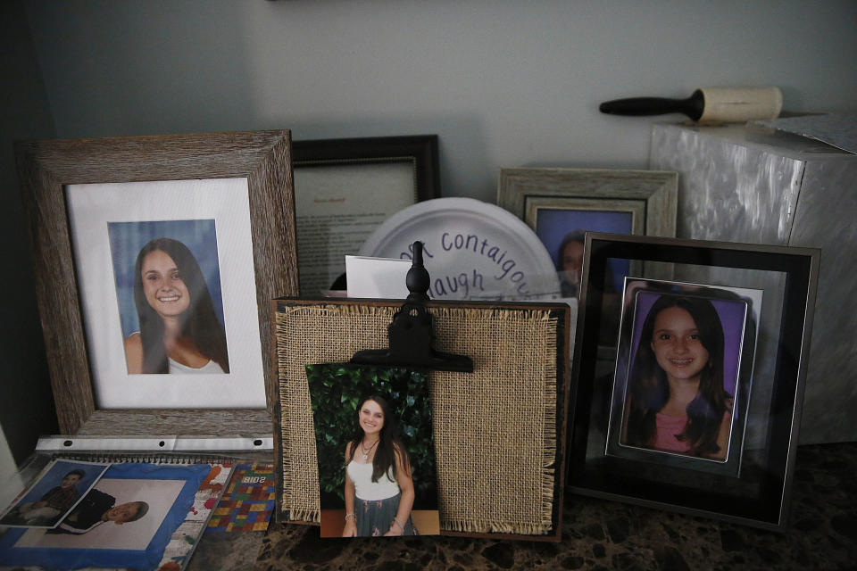 FILE - Photographs of 14-year-old Alyssa Alhadeff, one of 17 people killed by a gunman at Marjory Stoneman Douglas High School, sit on a table in her home in Parkland, Fla., on Jan. 30, 2019. (AP Photo/Brynn Anderson, File)