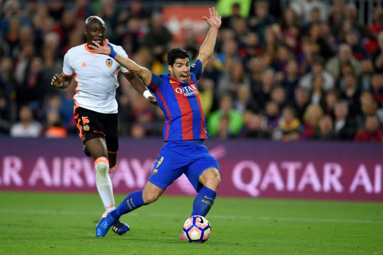 Barcelona's forward Luis Suarez (R) receives a penalty from play by Valencia's Brazilian defender Eliaquim Mangala on March 19, 2017