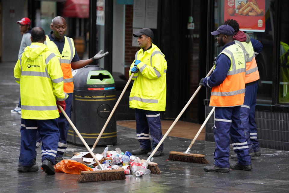 <p>Street cleaners clear debris in London's Leicester Square the morning after England were beaten in the final of the UEFA Euro 2020. Picture date: Monday July 12, 2021.</p>
