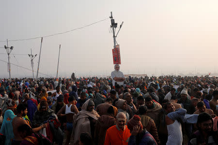 Devotees arrive to take a holy dip at Sangam, the confluence of the Ganges, Yamuna and Saraswati rivers, during "Kumbh Mela", or the Pitcher Festival, in Prayagraj, previously known as Allahabad, India, January 14, 2019. REUTERS/Danish Siddiqui