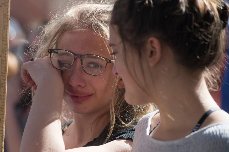 Bella Swanson, 13, wipes a tear away as she looks to her friend Bonnie Torres during a March for Our Lives event on on March 24, 2018. The gathering was a part of the national movement following the Parkland, Fla shooting.