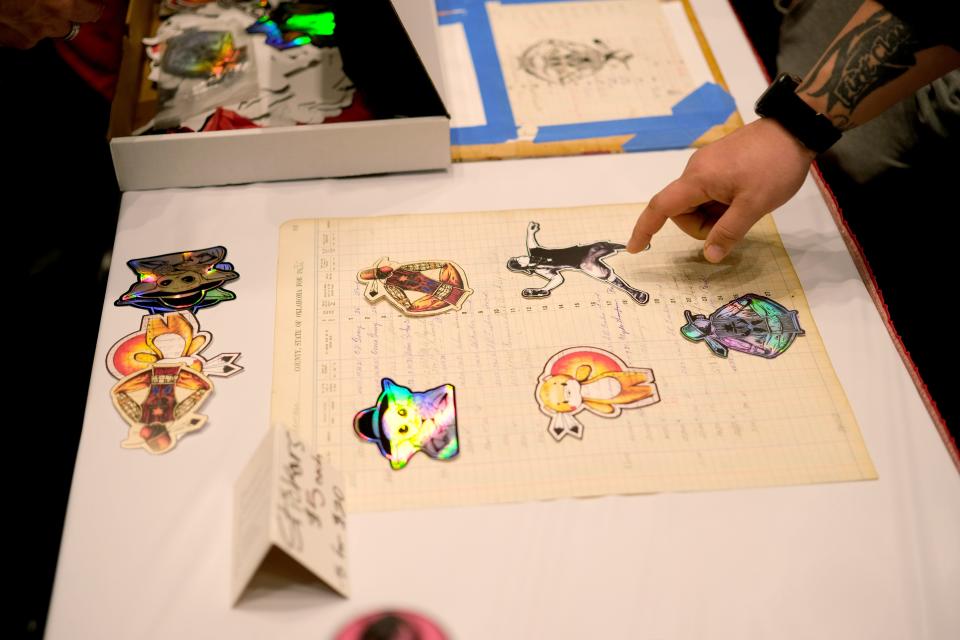 People look at stickers by Red Earth Honored One Brent Greenwood during the Red Earth Festival at the National Cowboy & Western Heritage Museum in Oklahoma City, Friday, March 22, 2024.