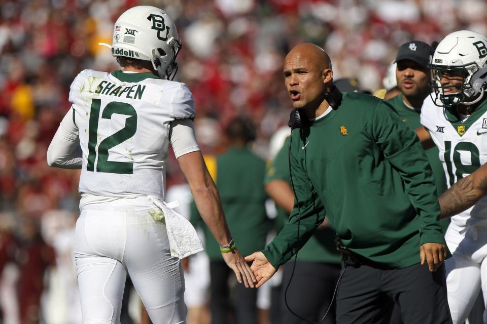 Baylor coach Dave Aranda, right, slaps the hand of quarterback Blake Shapen during game against Oklahoma, Saturday, Nov. 5, 2022, in Norman, Okla. Aranda, Shapen and the Bears are hoping to rebound from disappointing 2022 campaign. | Nate Billings, Associated Press