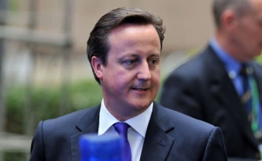 British Prime Minister David Cameron leaves after a second day of the European Union leaders summit in Brussels. British banks, including HSBC and Barclays, were Friday ordered to compensate businesses for "serious failings" over the sale of complex products, capping a scandal-hit week for lenders
