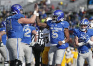 FILE - Air Force offensive lineman Scott Hattok (61) congratulates Air Force quarterback Donald Hammond III (5) after his plunge for a touchdown against Wyoming in the first half of an NCAA college football game Saturday, Nov. 30, 2019, at Air Force Academy, Colo. The offensive linemen for Air Force call themselves “Diesel,” a nickname invented a few seasons ago to personify the grit and toughness they use to help power the Falcons. (AP Photo/David Zalubowski, File)