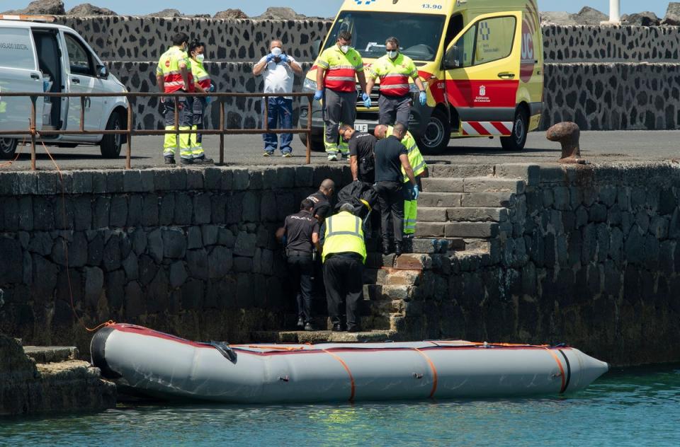 The body of a pregnant woman is taken ashore in Lanzarote, the Canaries on Tuesday (EPA)