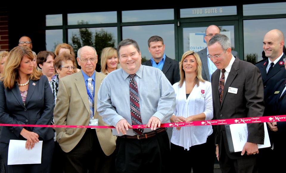 Moore Mayor Glenn Lewis helps cut the ribbon on the Oklahoma Recovery Center in the aftermath of the 2013 tornado.