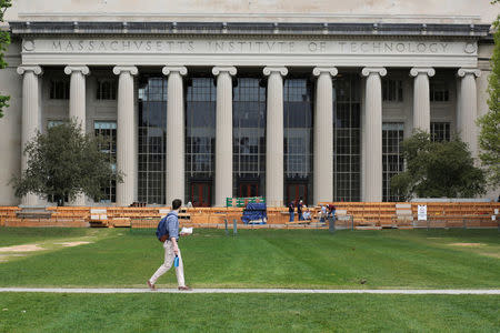 A man walks through Killian Court at the Massachusetts Institute of Technology (MIT) in Cambridge, Massachusetts, U.S., May 13, 2016. REUTERS/Brian Snyder