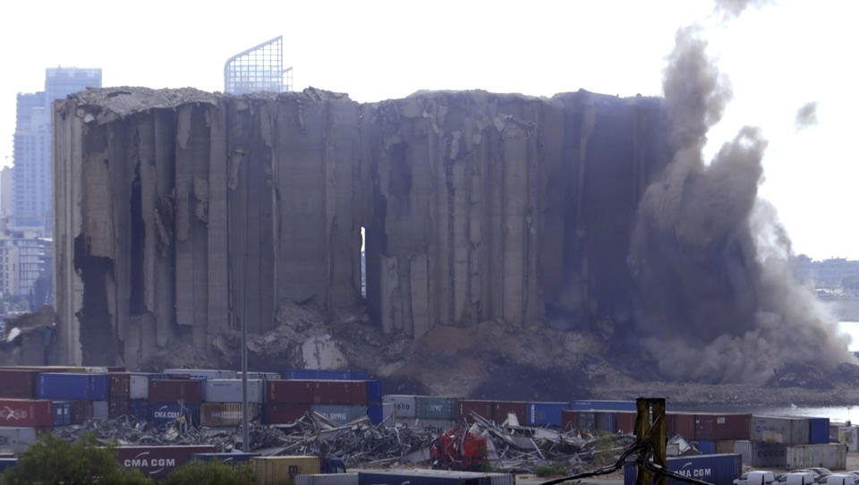 This frame grab from video shows part of the silos collapsing, in the port of Beirut, Lebanon, Sunday, July 31, 2022. A section of Beirut's massive port grain silos, shredded in the 2020 explosion, collapsed on Sunday after a weekslong fire triggered by grains that had fermented and ignited in the summer heat. (AP Photo)