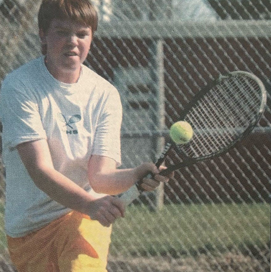 Ryan Schoenefeld of Watertown charges to hit a backhand shot during a 2004 high school boys tennis dual at Highland Park.