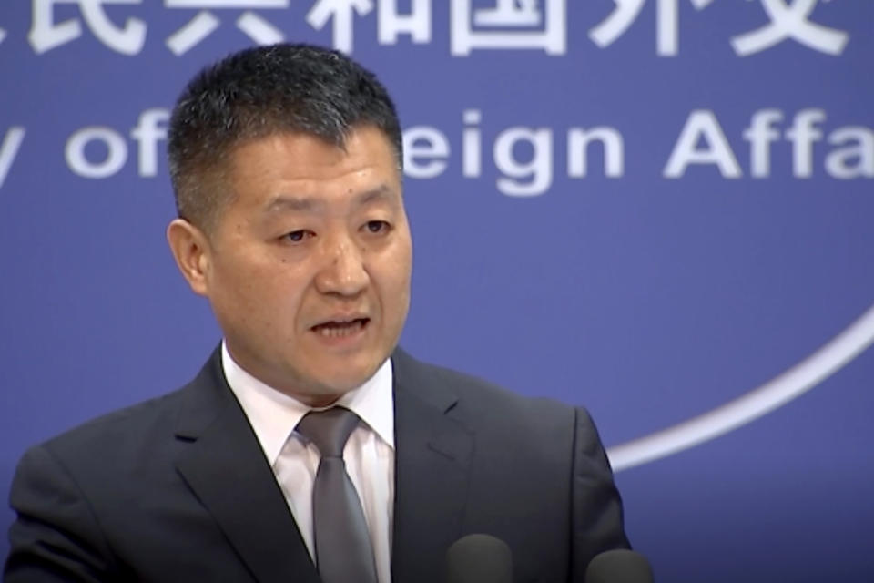 CORRECTS NAME OF SPOKESMAN - In this image from video, Chinese Foreign Ministry spokesman Lu Kang speaks during a media briefing which he commented on investigations into Chinese-Australian writer Yang Hengjun in Beijing Thursday, July 18, 2019. Yang who has been detained in Beijing since January was charged on Thursday and moved to a different detention center in the Chinese capital, his lawyer said. (AP Photo)
